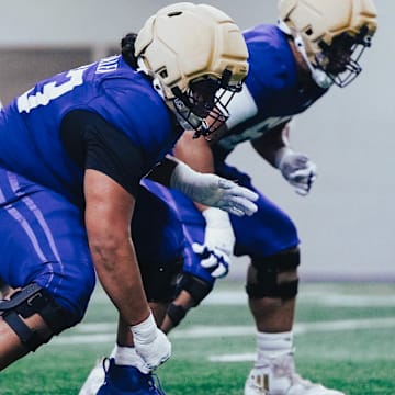 Champ Taulelea comes out of a stance during UW spring ball. 