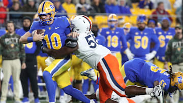 Nov 9, 2024; Pittsburgh, Pennsylvania, USA;  Pittsburgh Panthers quarterback Eli Holstein (10) is tackled by Virginia Cavaliers defensive tackle Anthony Britton (55) during the second quarter at Acrisure Stadium. Mandatory Credit: Charles LeClaire-Imagn Images
