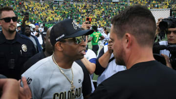 Colorado coach Deion Sanders and Oregon's Dan Lanning meet at midfield after the game at Autzen Stadium.