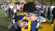 Cal interim head coach Nick Rolovich hugs quarterback Jaron-Keawe Sagapolutele after defeating SMU. 