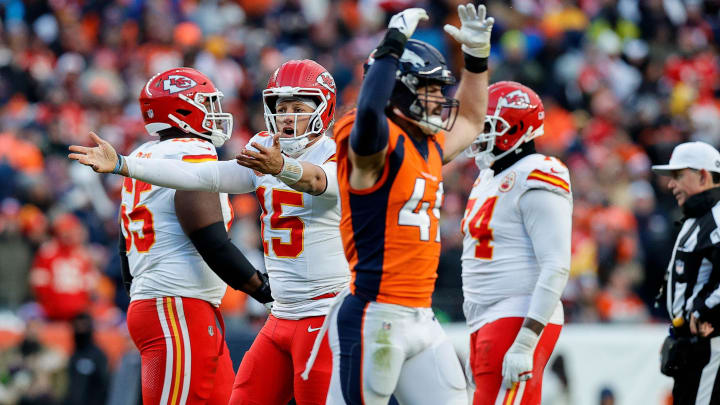 Oct 29, 2023; Denver, Colorado, USA; Kansas City Chiefs quarterback Patrick Mahomes (15) reacts as Denver Broncos linebacker Alex Singleton (49) gestures in the fourth quarter at Empower Field at Mile High. 