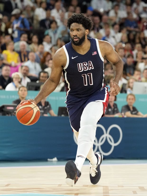 Team USA center Joel Embiid dribbles in the Olympics.