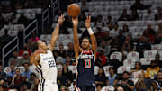 Oct 28, 2023; Washington, District of Columbia, USA; Washington Wizards guard Jordan Poole (13) shoots the ball over Memphis Grizzlies guard Desmond Bane (22) in the first quarter at Capital One Arena. Mandatory Credit: Geoff Burke-Imagn Images