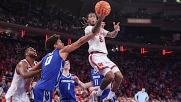 Feb 16, 2025; Queens, New York, USA;  St. John's basketball guard Deivon Smith (5) drives past Creighton Bluejays forward Jasen Green (0) in the second half at Madison Square Garden.