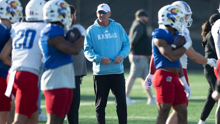 Kansas coach Lance Leipold talks with coaches and staff during outdoor practice on campus Thursday, March 13, 2025.
