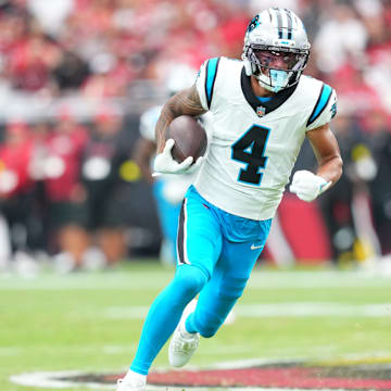Sep 14, 2025; Glendale, Arizona, USA; Carolina Panthers wide receiver Tetairoa McMillan (4) runs with the ball during the first quarter against the Arizona Cardinals at State Farm Stadium. 
