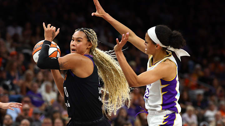 Sep 9, 2025; Phoenix, Arizona, USA; Phoenix Mercury forward Satou Sabally (0) drives to the basket against Los Angeles Sparks guard Rae Burrell (12) during the second half of a WNBA game at PHX Arena. Mandatory Credit: Mark J. Rebilas-Imagn Images