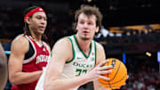Mar 13, 2025; Indianapolis, IN, USA; Oregon Ducks center Nate Bittle (32) holds the ball while Indiana Hoosiers forward Malik Reneau (5) defends in the second half at Gainbridge Fieldhouse.
