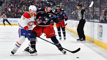 Blue Jackets forward Dmitri Voronkov fends off Canadiens defenseman Mike Matheson.