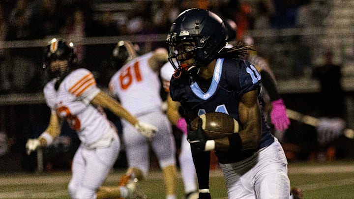 Guilford's Messiah Tilson (11) runs around defense during a game against Harlem on Friday, Sept. 27, 2024, at Guilford High School. Guilford's Messiah Tilson (11) runs around defense during a game against Harlem on Friday, Sept. 27, 2024, at Guilford High School.