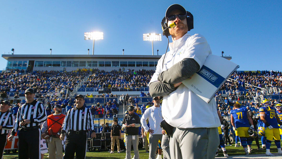 Delaware head coach Ryan Carty watches the coin toss before the Blue Hens' 35-7 loss to Villanova at Delaware Stadium, Saturday, Nov. 18, 2023.