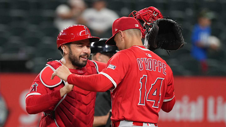 Angels catcher Travis d'Arnaud (25) and designated hitter Logan O'Hoppe (14) celebrate their team’s 4-0 win over the Texas Rangers following the ninth inning at Globe Life Field on Aug. 25.