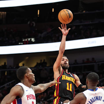 Feb 23, 2025; Atlanta, Georgia, USA; Atlanta Hawks guard Trae Young (11) shoots the ball over Detroit Pistons center Jalen Duren (0) and forward Tim Hardaway Jr. (8) during the fourth quarter at State Farm Arena. Mandatory Credit: Jordan Godfree-Imagn Images