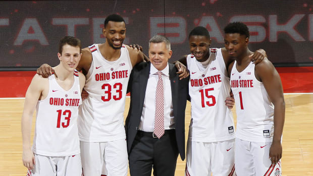 Ohio State Buckeyes head coach Chris Holtmann stands with seniors, from left, guard Andrew Dakich (13), forward Keita Bates-Diop (33), guard Kam Williams (15) and forward Jae'Sean Tate (1) during senior night festivities following the Buckeyes' 79-52 win over the Rutgers Scarlet Knights in the NCAA men's basketball game at Value City Arena in Columbus on Feb. 20, 2018. [Adam Cairns / Dispatch]