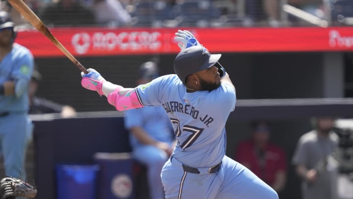 Jul 21, 2024; Toronto, Ontario, CAN; Toronto Blue Jays designated hitter Vladimir Guerrero Jr. (27) hits a double against the Detroit Tigers during the seventh inning at Rogers Centre. Mandatory Credit: John E. Sokolowski-USA TODAY Sports