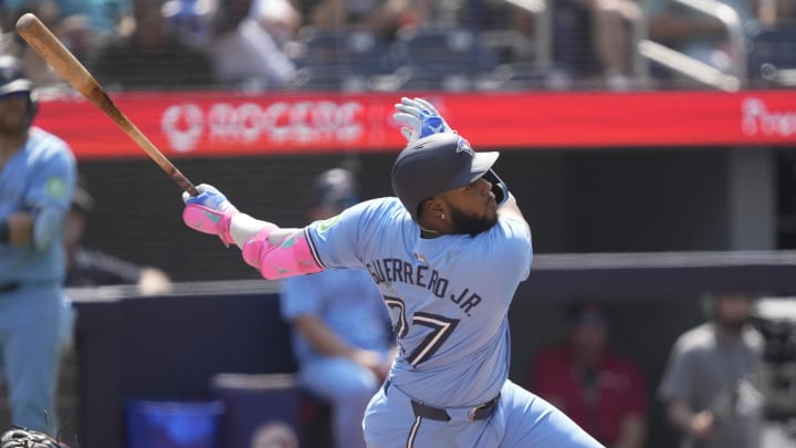 Jul 21, 2024; Toronto, Ontario, CAN; Toronto Blue Jays designated hitter Vladimir Guerrero Jr. (27) hits a double against the Detroit Tigers during the seventh inning at Rogers Centre. Mandatory Credit: John E. Sokolowski-USA TODAY Sports