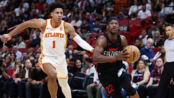 Jalen Johnson #1 of the Atlanta Hawks chases Jimmy Butler #22 of the Miami Heat.