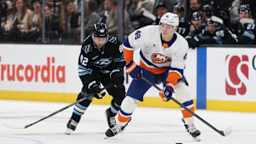 Nov 14, 2025; Salt Lake City, Utah, USA; New York Islanders defenseman Matthew Schaefer (48) skates with the puck against Utah Mammoth center Logan Cooley (92) during the second period at Delta Center. Mandatory Credit: Rob Gray-Imagn Images
