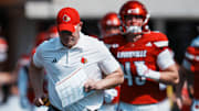 Louisville Cardinals head football coach Jeff Brohm runs onto the field with his team as they take on visiting Bowling Green in Louisville, Kentucky. Sept. 20, 2025