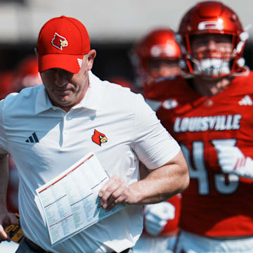 Louisville Cardinals head football coach Jeff Brohm runs onto the field with his team as they take on visiting Bowling Green in Louisville, Kentucky. Sept. 20, 2025