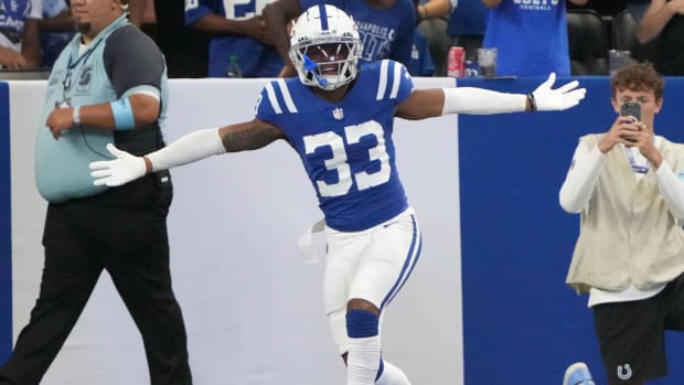 Colts cornerback Micah Abraham (blue jersey; white pants/helmet) celebrates a touchdown after a turnover. 