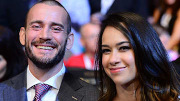 Former WWE superstars Phil Brooks aka CM Punk and April Mendez-Brooks aka AJ Lee attend the Chad Mendes