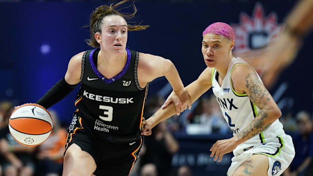 Connecticut Sun guard Marina Mabrey wearing a black uniform dribbles a basketball.