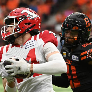 Jun 15, 2024; Vancouver, British Columbia, CAN;  Calgary Stampeders wide receiver Clark Barnes (14) runs with the ball against  BC Lions defensive back Ronald Kent Jr (21) during the second half at BC Place. Mandatory Credit: Simon Fearn-USA TODAY Sports