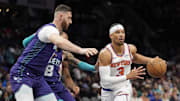 Mar 20, 2025; Charlotte, North Carolina, USA; New York Knicks guard Josh Hart (3) passes off under pressure from Charlotte Hornets center Jusuf Nurkic (11) during the first quarter at Spectrum Center. Mandatory Credit: Jim Dedmon-Imagn Images