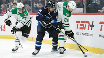 Mar 14, 2025; Winnipeg, Manitoba, CAN;  Winnipeg Jets defenseman Josh Morrissey (44) and Dallas Stars forward Mavrik Bourque battle for the puck during the second period at Canada Life Centre. Mandatory Credit: Terrence Lee-Imagn Images