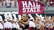 Mississippi State Bulldogs mascot Bully waves a Hail State flag prior to the game against the Texas Longhorns at Davis Wade Stadium at Scott Field.