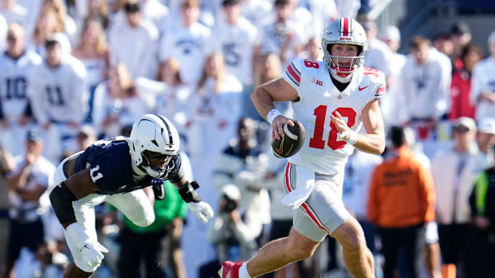 Ohio State Buckeyes quarterback Will Howard (18) runs past Penn State Nittany Lions defensive end Abdul Carter (11) during the NCAA football game at Beaver Stadium in University Park, Pa. on Monday, Nov. 4, 2024. Ohio State won 20-13.