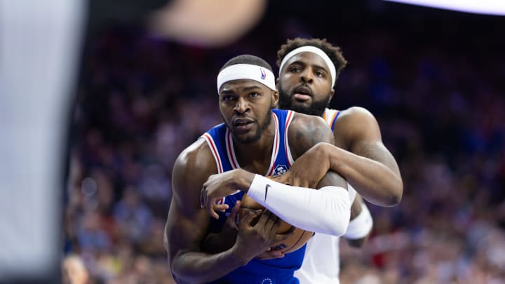 May 2, 2024; Philadelphia, Pennsylvania, USA; New York Knicks center Mitchell Robinson (23) and Philadelphia 76ers forward Paul Reed (44) wrestle for the ball during the second half of game six of the first round for the 2024 NBA playoffs at Wells Fargo Center. Mandatory Credit: Bill Streicher-USA TODAY Sports