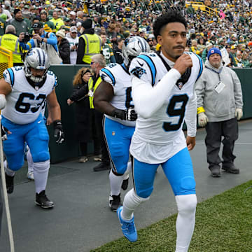 Caption:Nov 2, 2025; Green Bay, Wisconsin, USA; Carolina Panthers quarterback Bryce Young (9) runs onto the field prior to the game against the Green Bay Packers at Lambeau Field. 