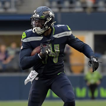 Aug 8, 2019; Seattle, WA, USA; Seattle Seahawks wide receiver D.K. Metcalf (14) runs the ball against Denver Broncos linebacker Keishawn Bierria (40) in the first half at CenturyLink Field. Mandatory Credit: Kirby Lee-Imagn Images