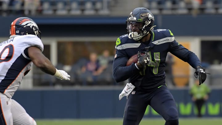 Aug 8, 2019; Seattle, WA, USA; Seattle Seahawks wide receiver D.K. Metcalf (14) runs the ball against Denver Broncos linebacker Keishawn Bierria (40) in the first half at CenturyLink Field. Mandatory Credit: Kirby Lee-Imagn Images