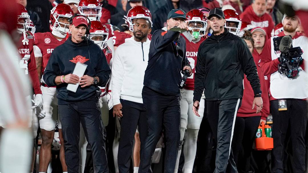 Offensive coordinator Ben Arbuckle talks with an official beside Oklahoma coach Brent Venables during a first-round College Football Playoff game between the University of Oklahoma Sooners (OU) and the Alabama Crimson Tide