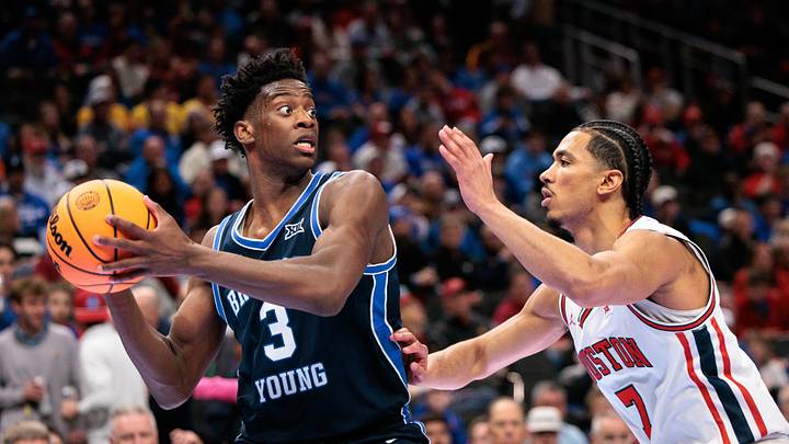 Mar 12, 2026; Kansas City, MO, USA; BYU Cougars forward AJ Dybantsa (3) protects the ball from Houston Cougars guard Milos Uzan (7) during the second half at T-Mobile Center. Mandatory Credit: William Purnell-Imagn Images