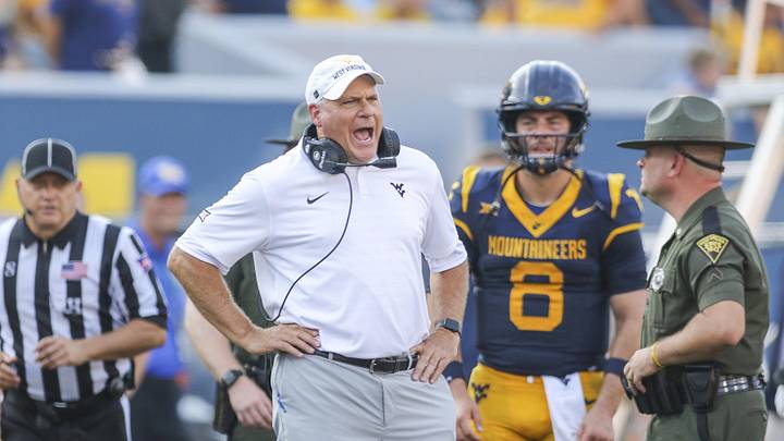 Sep 13, 2025; Morgantown, West Virginia, USA; West Virginia Mountaineers head coach Rich Rodriguez yells at the referee during the second quarter against the Pittsburgh Panthers at Milan Puskar Stadium. Mandatory Credit: Ben Queen-Imagn Images