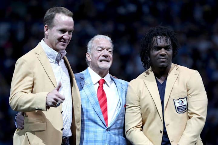 Peyton Manning and Edgerrin James stand with Jim Irsay after receiving their hall of fame rings.
