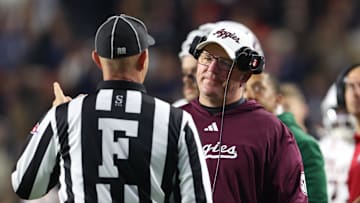 Nov 23, 2024; Auburn, Alabama, USA;  Texas A&M Aggies head coach Mike Elko speaks with a game official during the second quarter against the Auburn Tigers at Jordan-Hare Stadium. Mandatory Credit: John Reed-Imagn Images