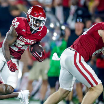 Oklahoma   s Marcus Major (24) runs the ball and is tripped up by Iowa State's T.J. Tampa (2) in the fourth quarter during an NCAA football game between University of Oklahoma (OU) and Iowa State at the Gaylord Family Oklahoma Memorial Stadium in Norman, Okla., on Saturday, Sept. 30, 2023.