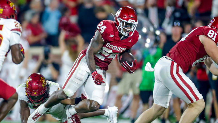 Oklahoma   s Marcus Major (24) runs the ball and is tripped up by Iowa State's T.J. Tampa (2) in the fourth quarter during an NCAA football game between University of Oklahoma (OU) and Iowa State at the Gaylord Family Oklahoma Memorial Stadium in Norman, Okla., on Saturday, Sept. 30, 2023.