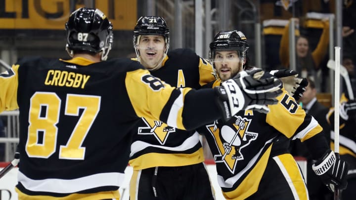 Mar 12, 2023; Pittsburgh, Pennsylvania, USA; Pittsburgh Penguins center Sidney Crosby (87) and center Evgeni Malkin (71) and defenseman Kris Letang (58) celebrate a game winning goal in overtime by Letang to defeat the New York Rangers at PPG Paints Arena. The Penguins won 3-2 in overtime. Mandatory Credit: Charles LeClaire-USA TODAY Sports