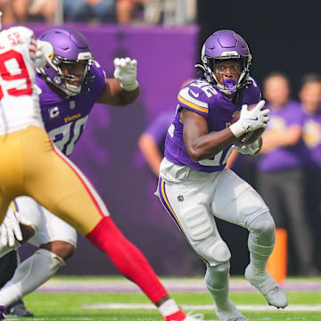 Sep 15, 2024; Minneapolis, Minnesota, USA; Minnesota Vikings running back Ty Chandler (32) runs with the ball against the San Francisco 49ers in the second quarter at U.S. Bank Stadium. Mandatory Credit: Brad Rempel-Imagn Images