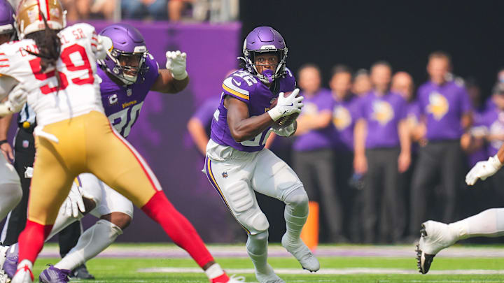 Sep 15, 2024; Minneapolis, Minnesota, USA; Minnesota Vikings running back Ty Chandler (32) runs with the ball against the San Francisco 49ers in the second quarter at U.S. Bank Stadium. Mandatory Credit: Brad Rempel-Imagn Images