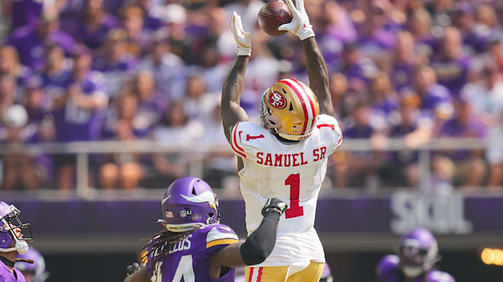 Sep 15, 2024; Minneapolis, Minnesota, USA; San Francisco 49ers wide receiver Deebo Samuel Sr. (1) catches the ball against the Minnesota Vikings safety Josh Metellus (44) in the second quarter at U.S. Bank Stadium. Mandatory Credit: Brad Rempel-Imagn Images