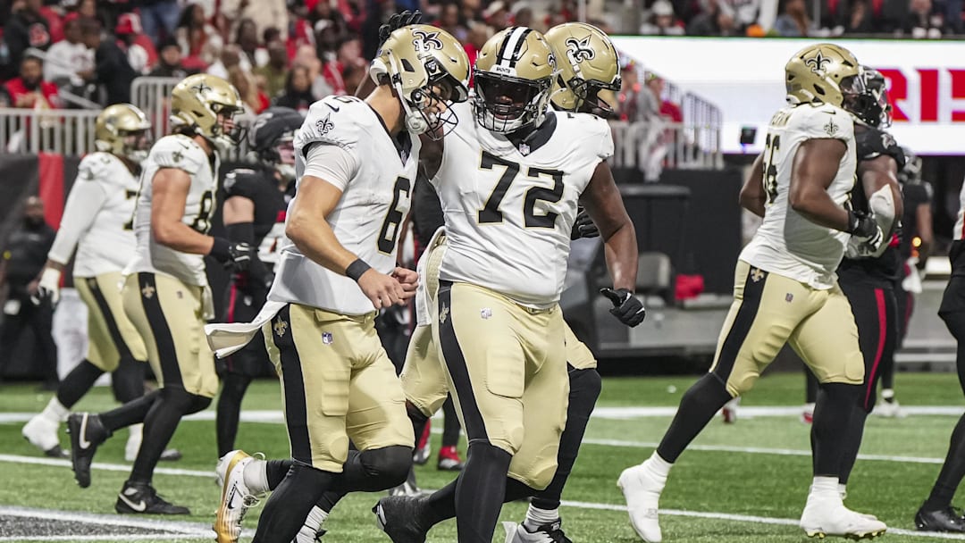Jan 4, 2026; Atlanta, Georgia, USA; New Orleans Saints quarterback Tyler Shough (6) and offensive tackle Asim Richards (72) celebrate after a touchdown run during the game against the Atlanta Falcons during the first half at Mercedes-Benz Stadium. Mandatory Credit: Dale Zanine-Imagn Images