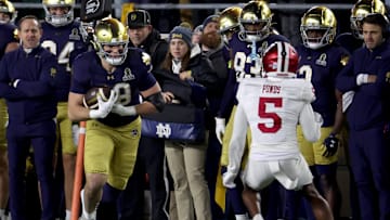 Dec 20, 2024; Notre Dame, Indiana, USA; Notre Dame Fighting Irish tight end Mitchell Evans (88) runs against Indiana Hoosiers defensive back D'Angelo Ponds (5) during the second half at Notre Dame Stadium. Mandatory Credit: Trevor Ruszkowski-Imagn Images