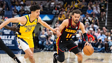 Apr 14, 2024; Indianapolis, Indiana, USA; Atlanta Hawks guard Trae Young (11) dribbles the ball while  Indiana Pacers guard Ben Sheppard (26) defends in the second half at Gainbridge Fieldhouse. Mandatory Credit: Trevor Ruszkowski-Imagn Images